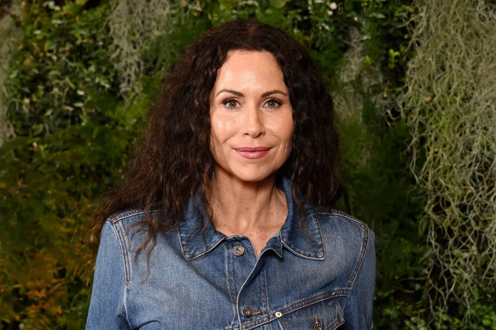 Minnie Driver smiling at a red carpet event.