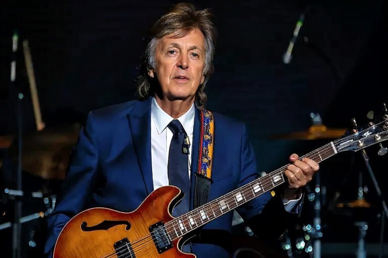 Paul McCartney smiling at an event.