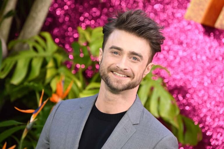 Daniel Radcliffe smiling at an event, estimated net worth of $110 million in 2025.
