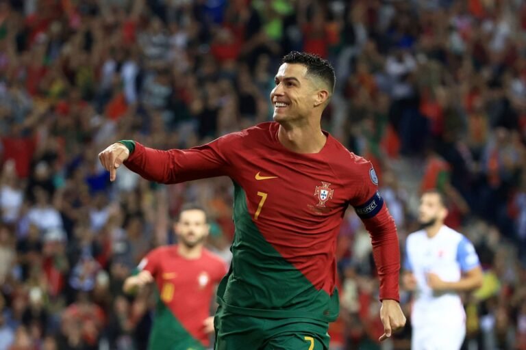 Cristiano Ronaldo in suit smiling, symbolizing his $500 million net worth in 2025