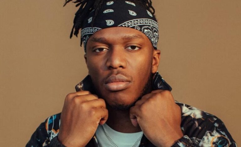 KSI posing confidently in front of a luxury car, representing his success and $100 million net worth in 2025.