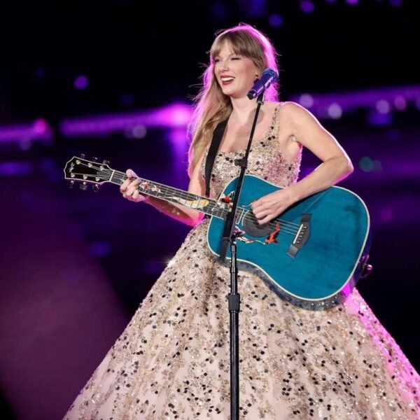 Taylor Swift smiling at a red carpet event, representing her success and $1.6 billion net worth in 2025.