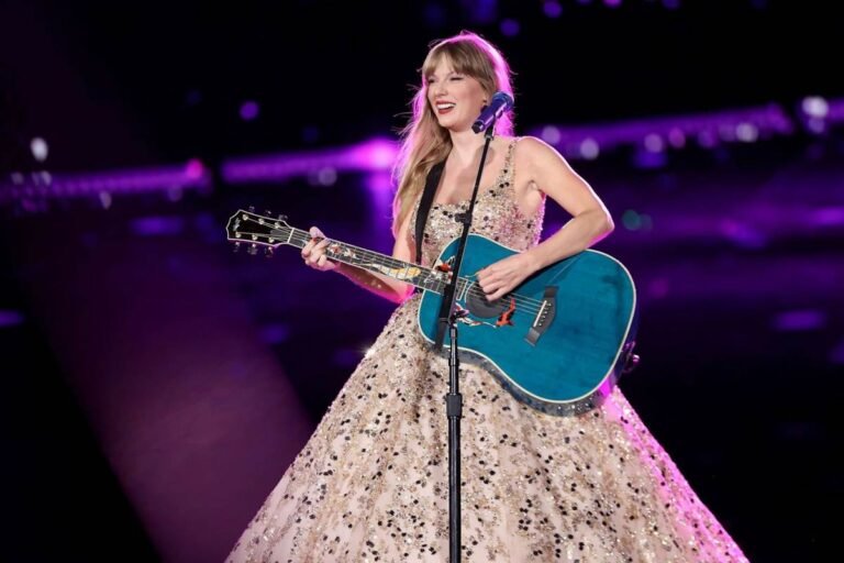 Taylor Swift smiling at a red carpet event, representing her success and $1.6 billion net worth in 2025.
