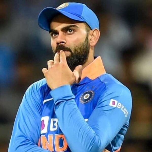 Virat Kohli smiling during a public event – representing his success and net worth in 2025.