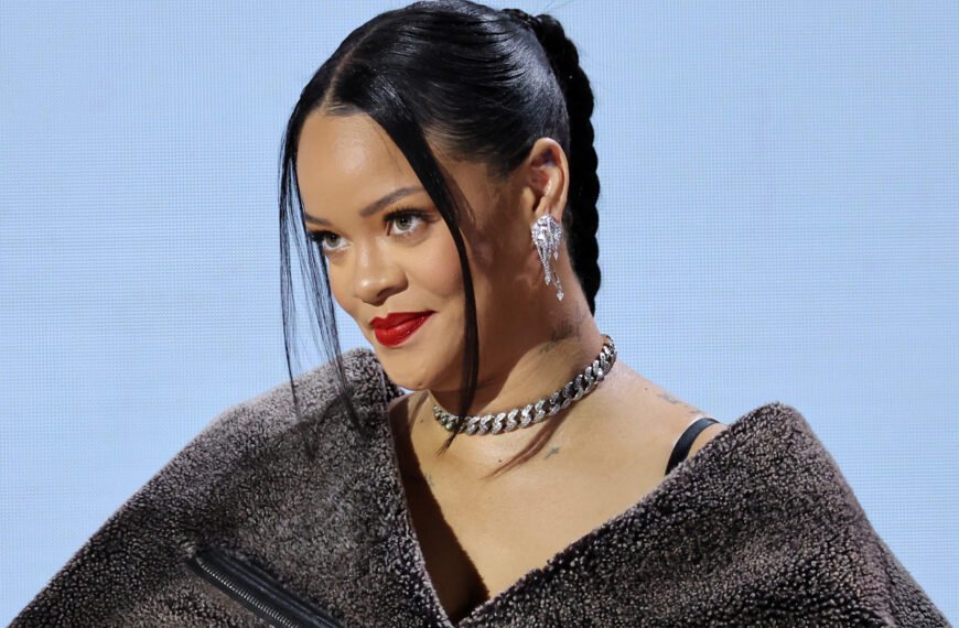 Rihanna smiling in a stylish outfit, symbolizing her $1.7 billion net worth in 2025 from music, Fenty Beauty, and fashion ventures.
