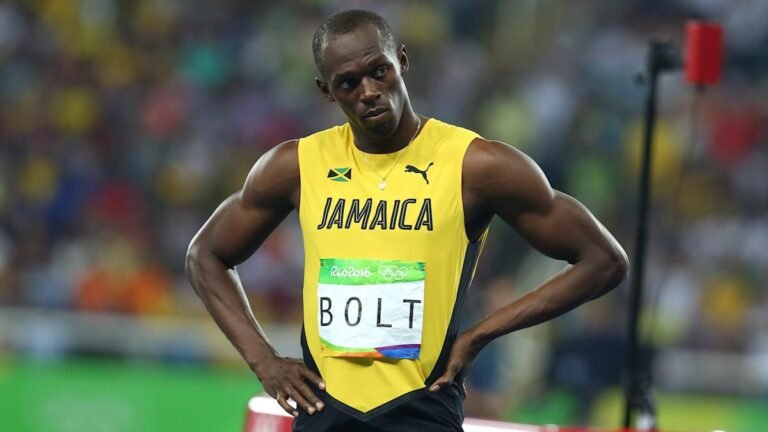 Usain Bolt smiling on the track, Jamaican sprinter and Olympic gold medalist, fastest man in the world with multi-million net worth.