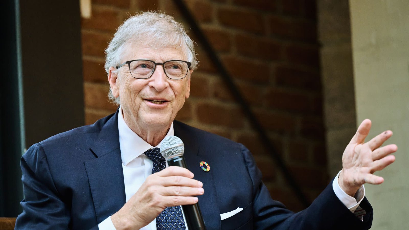 Bill Gates smiling during an interview – Bill Gates net worth 2025